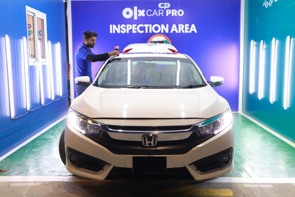 OLX CarPro Inspector carrying out a car inspection at the facilitation center in Lahore. 