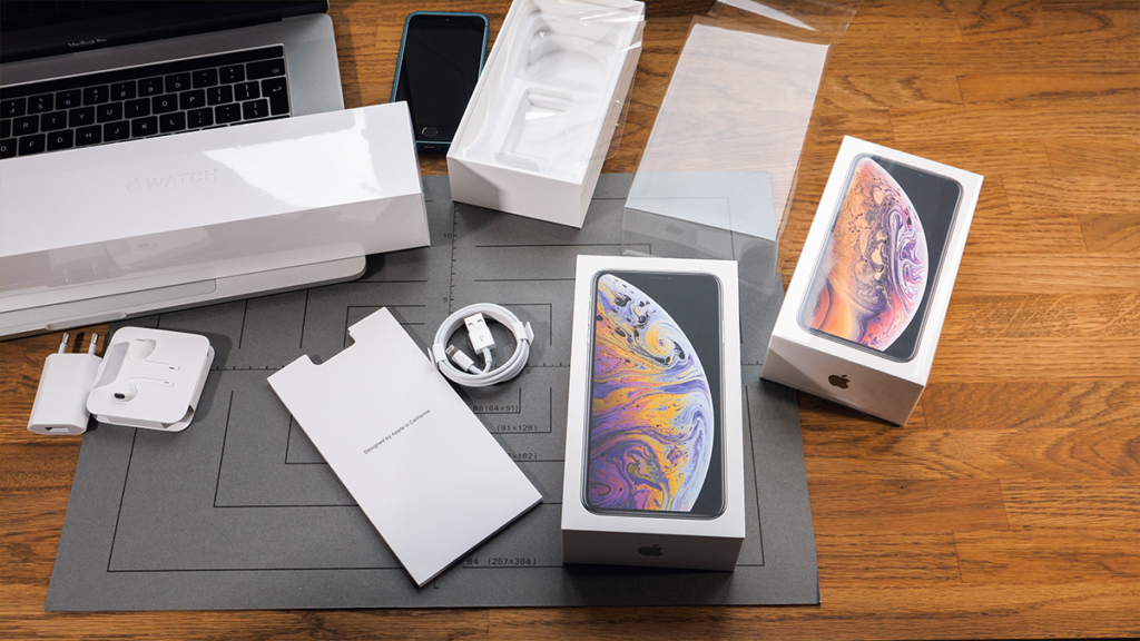 Generic view of iphones and apple products being unboxed.